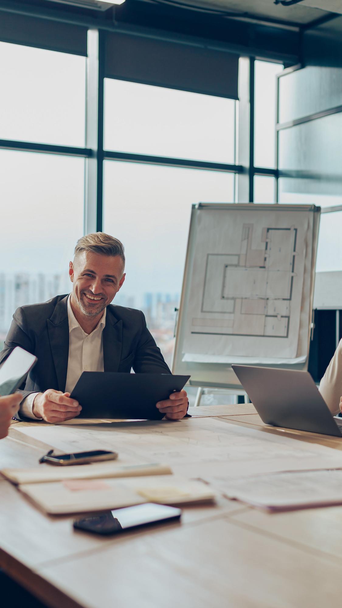 Agent reviewing floor plans at desk